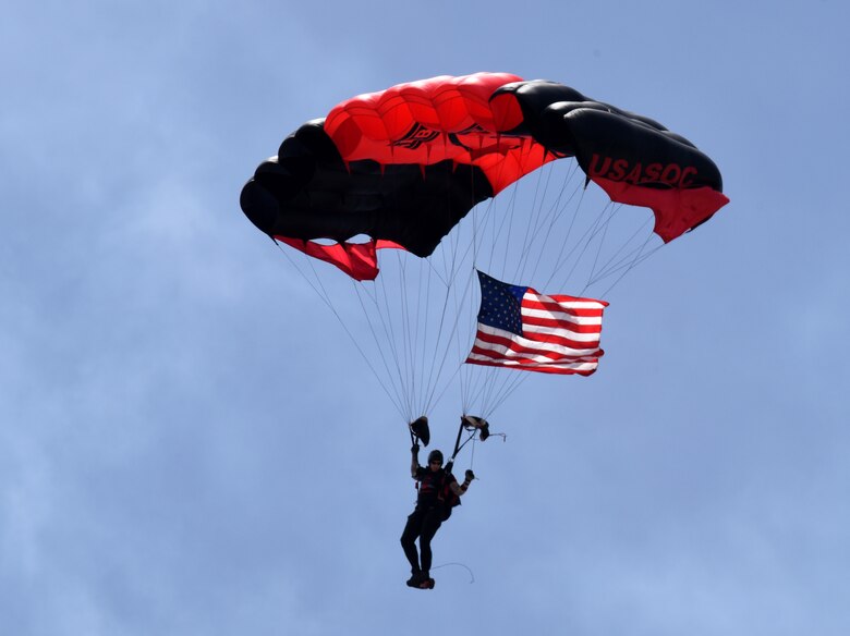 The Black Daggers, U.S. Army Special Operations Command Parachute Demonstration Team, carry the U.S. Flag during the Keesler and Biloxi Air and Space Show in Biloxi, Mississippi, May 5, 2019. The U.S. Air Force Thunderbirds are headlining the Keesler and Biloxi Air and Space Show May 4-5. Thunder Over the Sound is a unique, one-of-a-kind event where a base and its surrounding city jointly host an air show geographically separated. (U.S. Air Force photo by Kemberly Groue)
