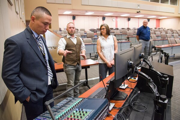 From left, Tracy Phillips, chief of the Facility Technology Integration Branch; Chris Harvel, project manager with the Communications Infrastructure and Systems Support program; Stacy Freeman, CIS2 program manager; and John Santy, project manager representing U.S. Southern Command, review the progress of a project to modernize the facility communication distribution systems in the Conference Center of the Americas at the U.S. Southern Command headquarters in Doral, Florida, during a visit to the facility April 1, 2019. The upgrade expands the capabilities of the CCA, which regularly accommodates heads of state from the SOUTHCOM area of responsibility.
