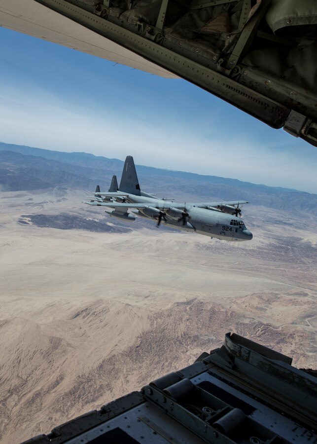 Three KC-130J Super Hercules with Marine Aerial Refueler Transport Squadron (VMGR) 352, Marine Aircraft Group 11, 3rd Marine Aircraft Wing, conduct a ceremonial formation flight for the VMGR-352 75th anniversary at Marine Corps Air Station Miramar, Calif., March 30. The squadron held a battle color ceremony, which consisted of a reading of the unit’s citations and awards, a color guard, performance by the 3rd MAW band, and a ceremonial formation flight. (U.S. Marine Corps photo by Lance Cpl. Clare J. McIntire/released)