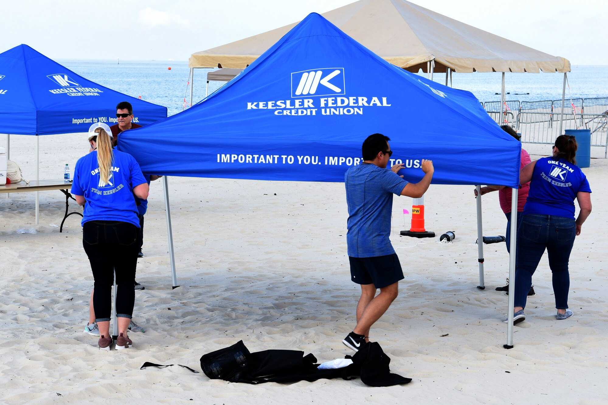 Keesler Federal Credit Union employees set up a tent in preparation for the Keesler and Biloxi Air and Space Show in Biloxi, Mississippi, May 3, 2019. Thunder Over the Sound is a unique, one-of-a-kind event where a base and its surrounding city jointly host one air show geographically separated.(U.S. Air Force photo by Senior Airman Jenay Randolph)