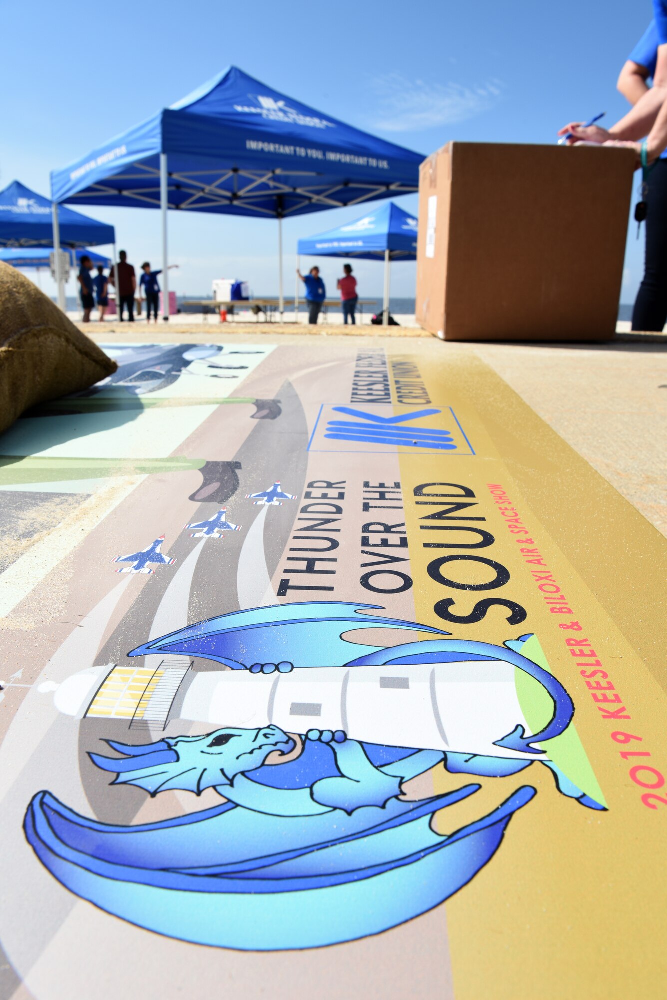 A Keesler Federal Credit Union air show themed board is displayed during set up for the Keesler and Biloxi Air and Space Show in Biloxi, Mississippi, May 3, 2019. Thunder Over the Sound is a unique, one-of-a-kind event where a base and its surrounding city jointly host one air show geographically separated. (U.S. Air Force photo by Senior Airman Jenay Randolph)