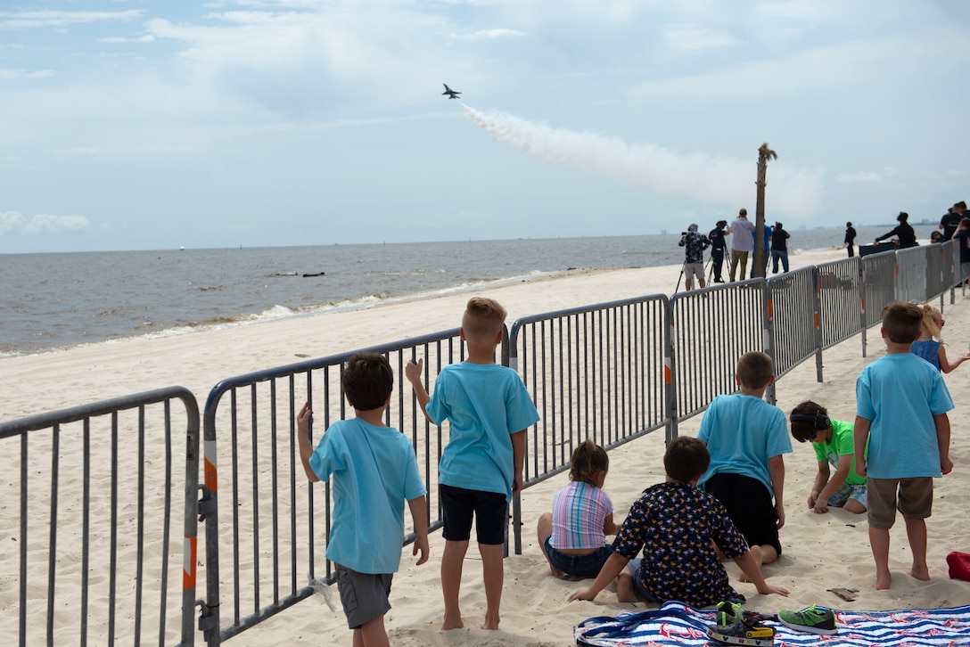 Children in the Make-A-Wish program and their families line up to watch the Thunderbirds fly during a practice session for the Keesler and Biloxi Air Show in Biloxi, Mississippi, May 3, 2019. After the practice session, the families were able to meet and get photos with the Thunderbird team. (U.S. Air Force photo by Airman 1st Class Kimberly L. Mueller)