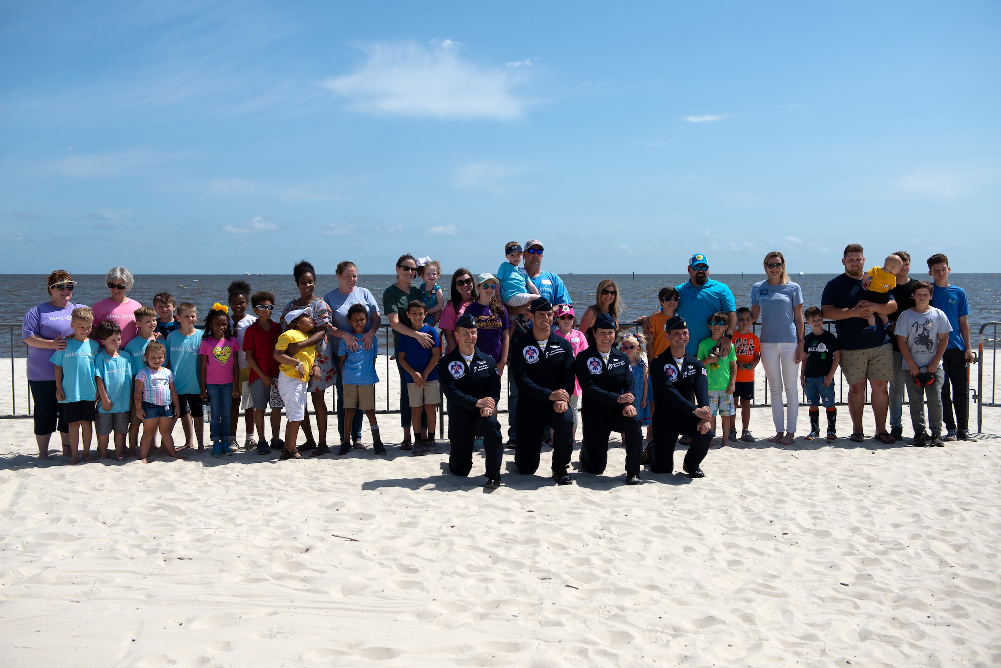 Make-A-Wish families pose for a group photo with the U.S. Air Force Thunderbirds in Biloxi, Mississippi, May 3, 2019. After viewing the Thunderbirds' practice session for the Keesler and Biloxi Air Show, the families had the opportunity to meet and speak with members of the Thunderbirds' team. (U.S. Air Force photo by Airman 1st Class Kimberly L. Mueller)