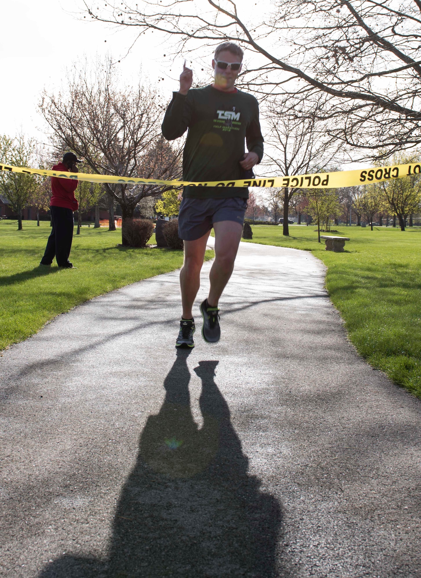 The first Team Fairchild runner passes the finish line at the commemorative Shell 77 5K Run at Fairchild Air Force Base, Washington, May 3, 2019. A Shell 77 memorial was dedicated at Fairchild AFB exactly one year after a tragic crash claimed the lives of three deployed Airmen over the hills of Kyrgyzstan, while flying in support of Operation Enduring Freedom. (U.S. Air Force photo by Senior Airman Ryan Lackey)