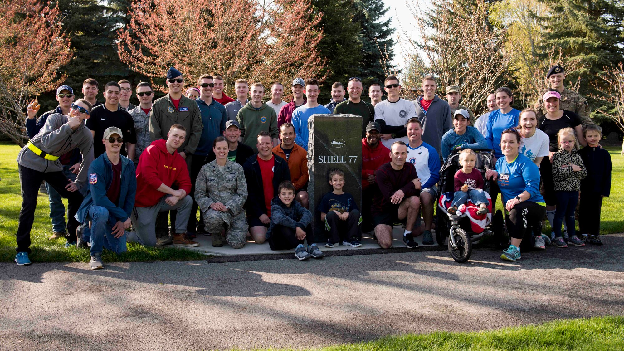 Team Fairchild Airmen gather for a group photo after the completion of the commemorative Shell 77 5K Run at Fairchild Air Force Base, Washington, May 3, 2019. The crew of Shell 77 included Capt. Tyler Voss, Capt. Victoria Pinckney and Tech. Sgt. Tre Mackey III; all members of the 93rd Air Refueling Squadron out of Fairchild AFB. (U.S. Air Force photo by Senior Airman Ryan Lackey)