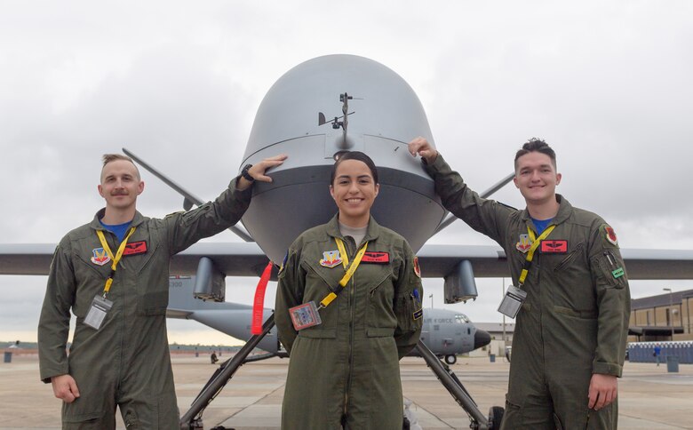 U.S. Air Force 1st Lt. Jeffery, Airman 1st Class Jacqueline and  Dallas, 15th Attack Squadron MQ-9 Reaper sensor operators from Creech Air Force Base, Nevada, pose for a photo with an MQ-9 Reaper Unmanned Aerial Vehicle during the Keesler and Biloxi Air and Space Show on Keesler Air Force Base, Mississippi, May 4, 2019. TThe U.S. Air Force Thunderbirds headline the unique, one-of-a-kind joint air show, May 4-5, that is geographically separated from the base and the city's beach front. (U.S. Air Force photo by Andre Askew)