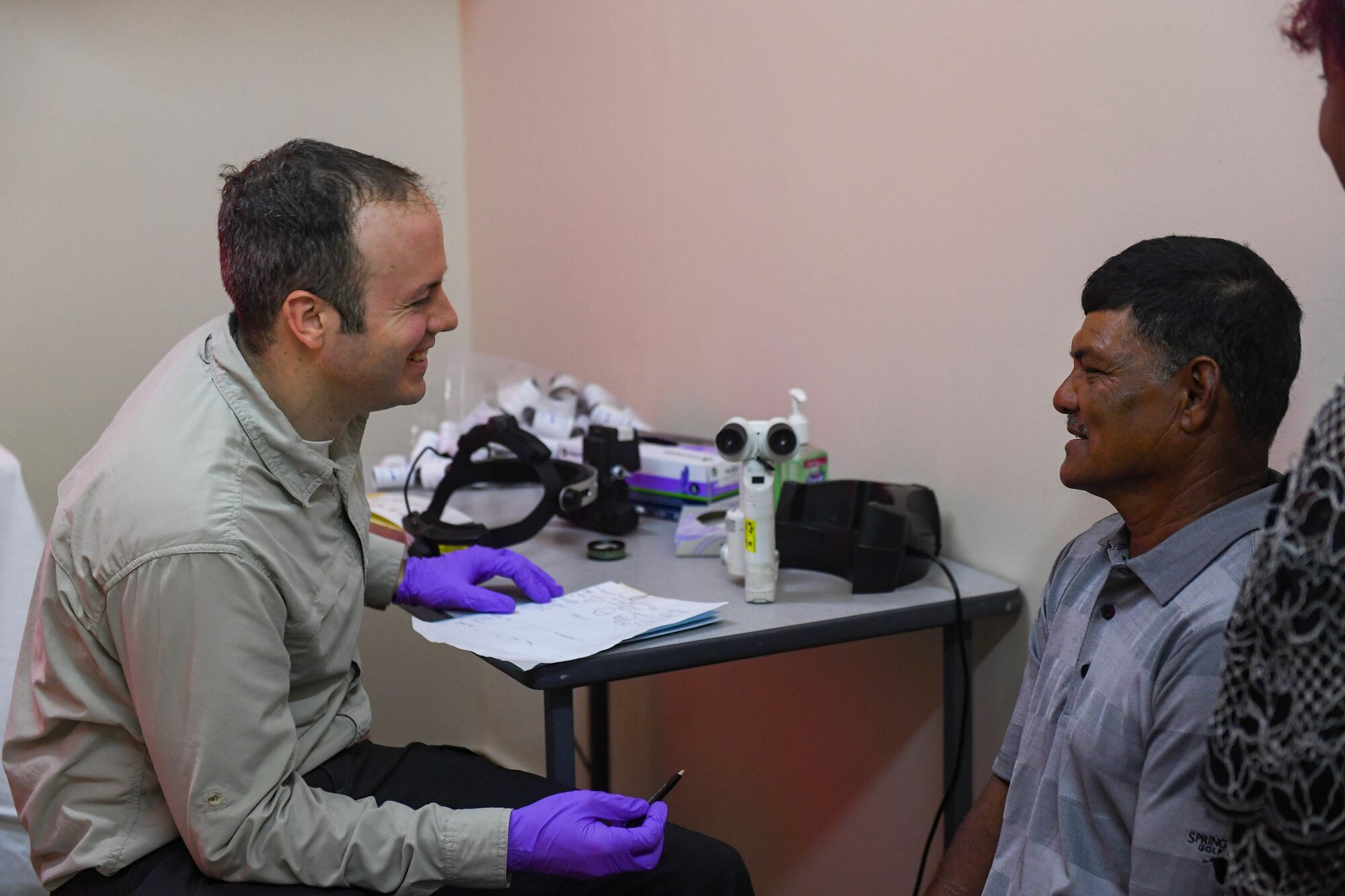 U.S. Air Force Lt. Col. James Richard Townley, ophthalmologist from Joint Base Elmendorf-Richardson, Alaska, talks with a patient during the New Horizons exercise 2019 at Port Mourant, Guyana, May 3, 2019.