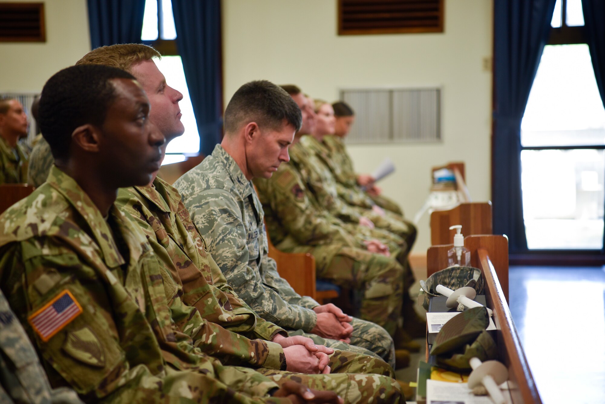 Airmen attentively listen to Rabbi (Maj.) Gary Davidson, U.S. Air Force chaplain, at Base Chapel a Holocaust Remembrance Ceremony on Kunsan Air Base, Republic of Korea, May 2, 2019. The ceremony commemorated the millions of victims and survivors of the Holocaust and the heroes whose actions saved countless amount of lives. (U.S. Air Force photo by Capt. Remoshay Nelson)