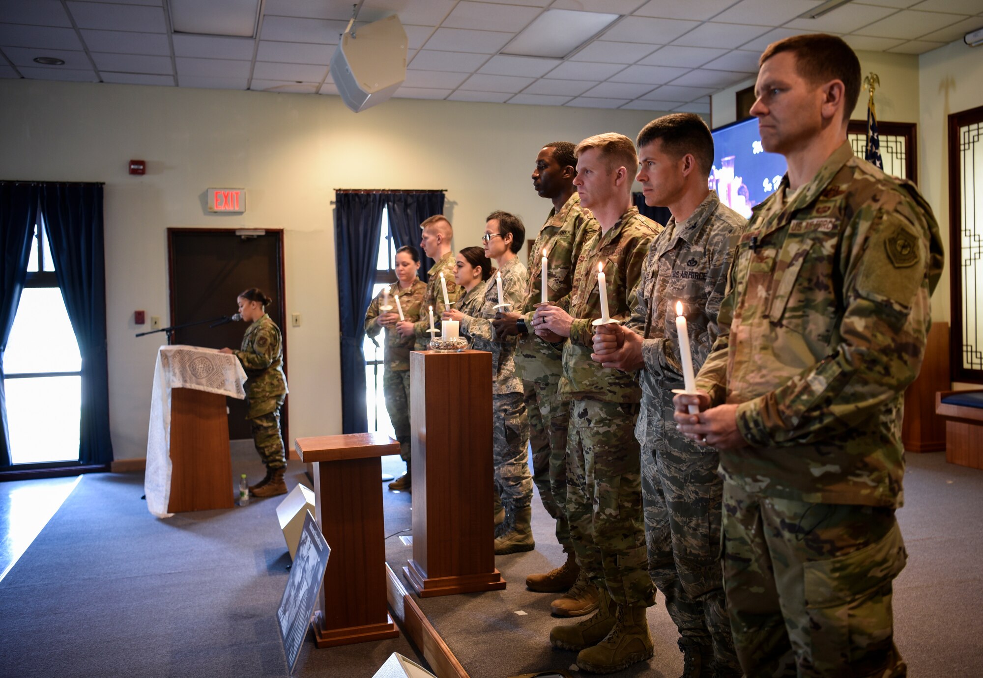 Airmen hold candles to commemorate Holocaust victims and survivors during a remembrance ceremony on Kunsan Air Base, Republic of Korea, May 2, 2019. The theme of this year’s remembrance is “Learning from the Holocaust: Beyond Religious Boundaries,” and while many Holocaust victims were in fact Jewish, other innocent targets included Polish, Africans, Muslims, and people with disabilities. (U.S. Air Force photo by Capt. Remoshay Nelson)