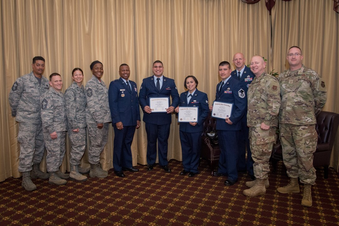 Reserve Citizen Airmen from the 514th Air Mobility Wing, Joint Base McGuire-Dix-Lakehurst, N.J., pose for a photo following a Community College of the Air Force graduation, May 3, 2019.