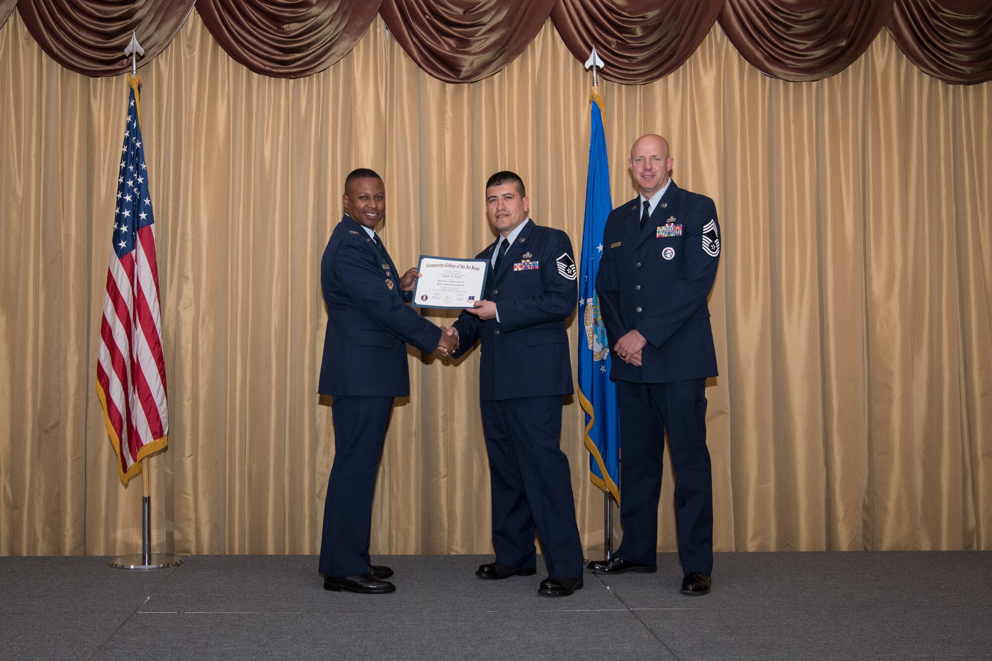 Master Sgt. Michael N. Ramos, 514th Maintenance Squadron, 514th Air Mobility Wing, Joint Base McGuire-Dix-Lakehurst, N.J., is presented with his Community College of the Air Force Associates Degree by Col. Adrian R. Byers, 514th AMW vice commander, May 3, 2019.