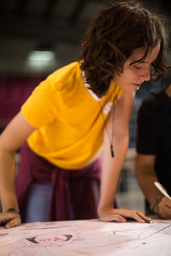 A girl draws as she waits for medical care at Ponce, Puerto Rico, May 2, 2019, during Innovative Readiness Training Puerto Rico. IRT Puerto Rico is also called Ola de Esperanza Sanadora, which translates to Healing Wave of Hope. This IRT is part of a civil and joint military program to improve military readiness while simultaneously providing quality services to underserved communities throughout the United States. (U.S. Marine Corps photo by Lance Cpl. Faeth Webb)