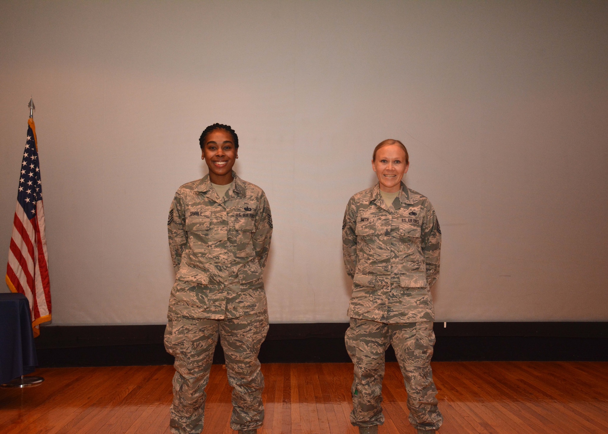 Tech. Sgt. Jocilyn Grable, 507th Air Refueling Wing Development and Training Flight program manager, and Master Sgt. Jessica Smith, 507th Operations Group career assistance advisor, are recognized for recently attaining Community College of the Air Force degrees during the May UTA commander's call at the base theater, May 5, 2019, Tinker Air Force Base, Oklahoma. (U.S. Air Force photo by Senior Airman Mary Begy)