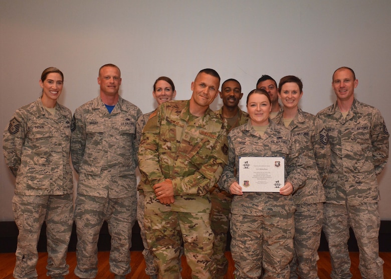 Senior Airman Melisa Rose, 507th Logistics Readiness Squadron, stands with the 507th Air Refueling Wing first sergeants for a photograph after receiving the Diamond Sharp award during commander's call May 5, 2019, Tinker Air Force Base, Oklahoma. (U.S. Air Force photo by Senior Airman Mary Begy)