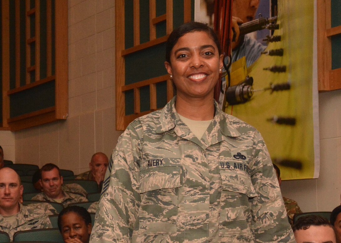 Chief Master Sgt. Taunya Avery, 507th Maintenance Group command chief, stands to be recognized during commander's call at the base theater, May 5, 2019, Tinker Air Force Base, Oklahoma. Avery will be acting as the 507th Air Refueling Wing's command chief while the current one is deployed. (U.S. Air Force photo by Senior Airman Mary Begy)