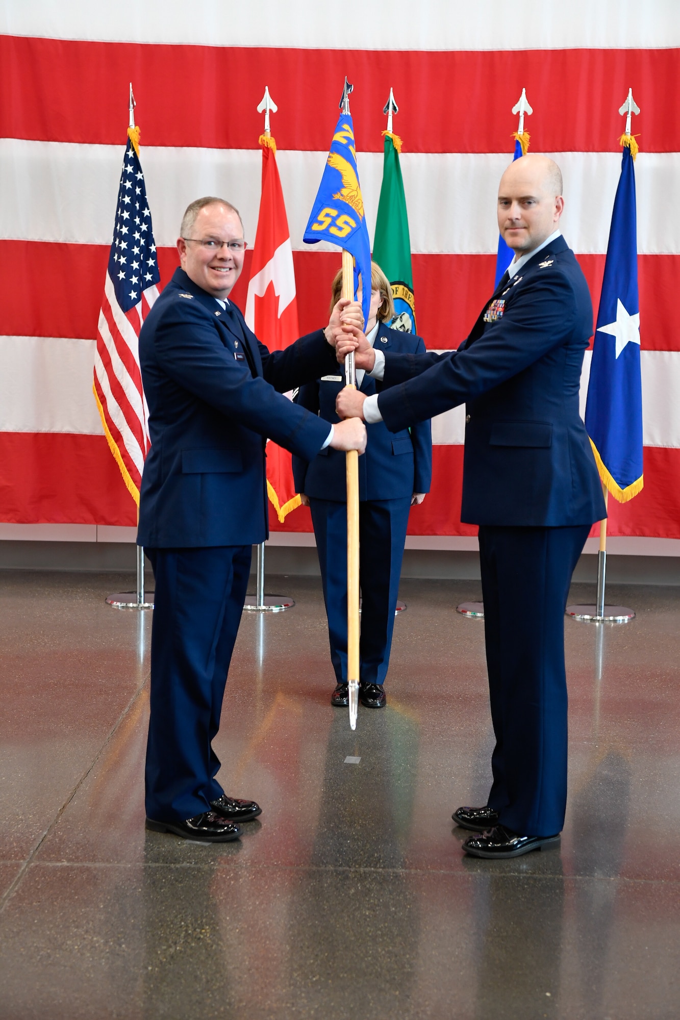 Col. Scott Humphrey presides over the 225th Support Squadron Change of Command where Col. Paige Abbott relinguishes command to Col. Brett Bosselmann at the Pierce County Readiness Center, Camp Murray, Washington, April 10, 2019. (U.S. Air National Guard photo by Capt. Colette Muller)