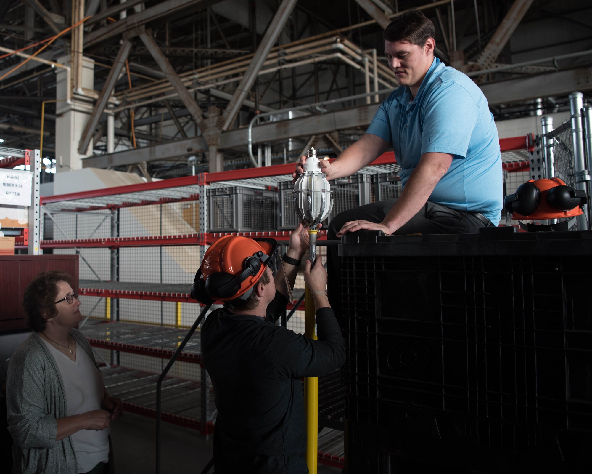 Members on base work together to help change the lighting at Joint Base Langley-Eustis, Virginia, April 30, 2019. Airmen who worked in this facility previously had to rely on natural light coming through the windows to be able to see. (U.S. Air Force photo by Airman 1st Class Marcus M. Bullock)
