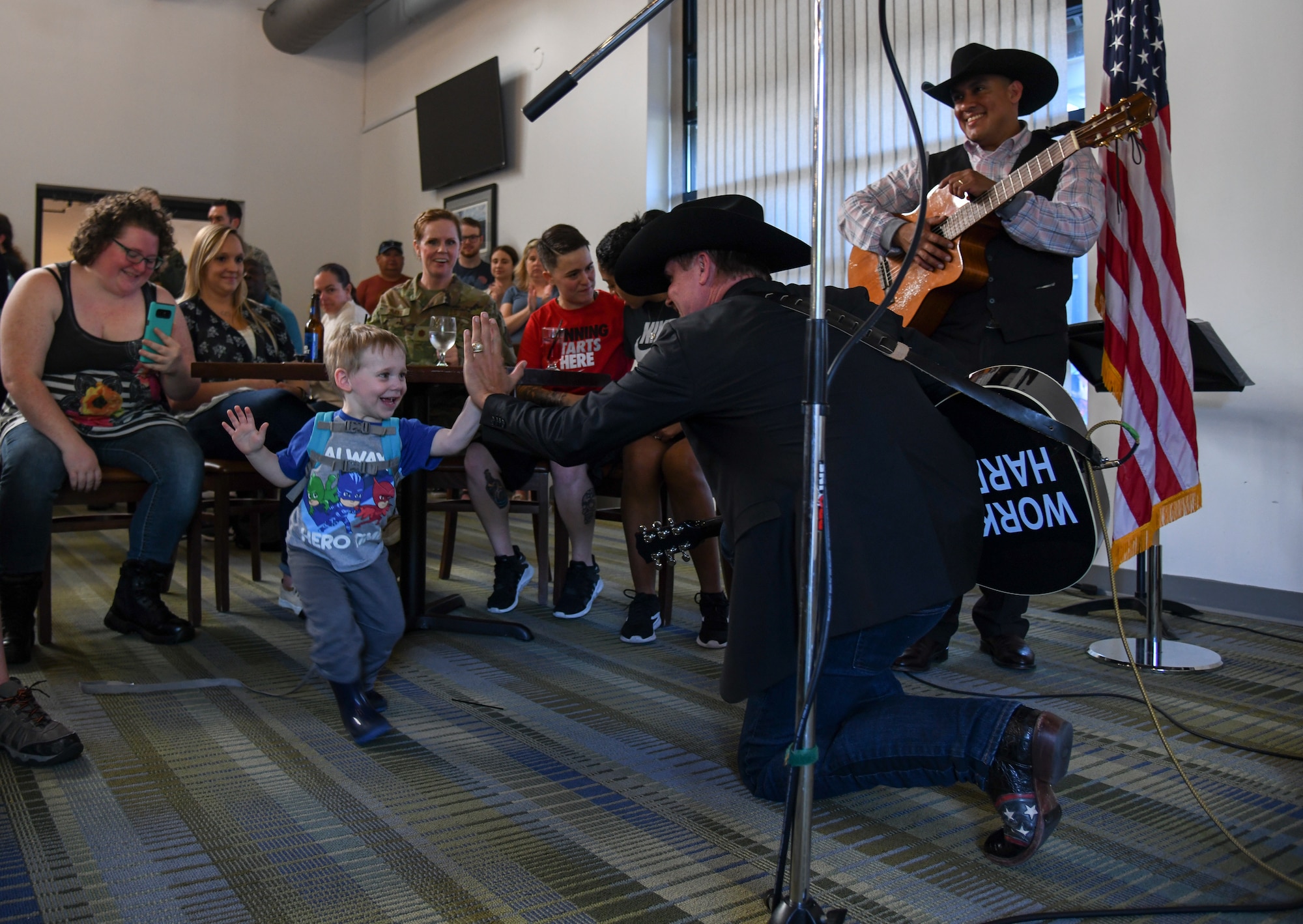 John Rich, american singer-songwriter of "Big & Rich", shares a high-five with a child from the crowd May 3, 2019, at The Landings on Dover Air Force Base, Del. Rich performed for servicemembers and their families during Dover's monthly First Friday social. The concert was held in conjunction with NASCAR weekend and included stock cars from professional NASCAR drivers.