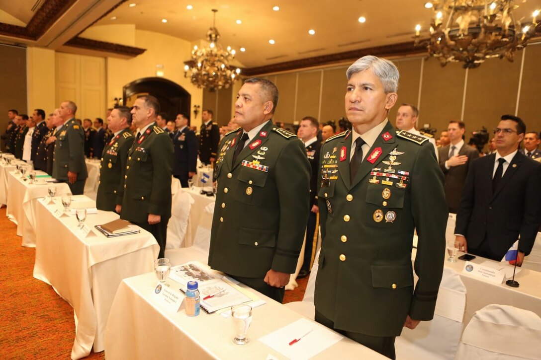 Multinational military members stand at attention during the opening of the Central American Security Conference.