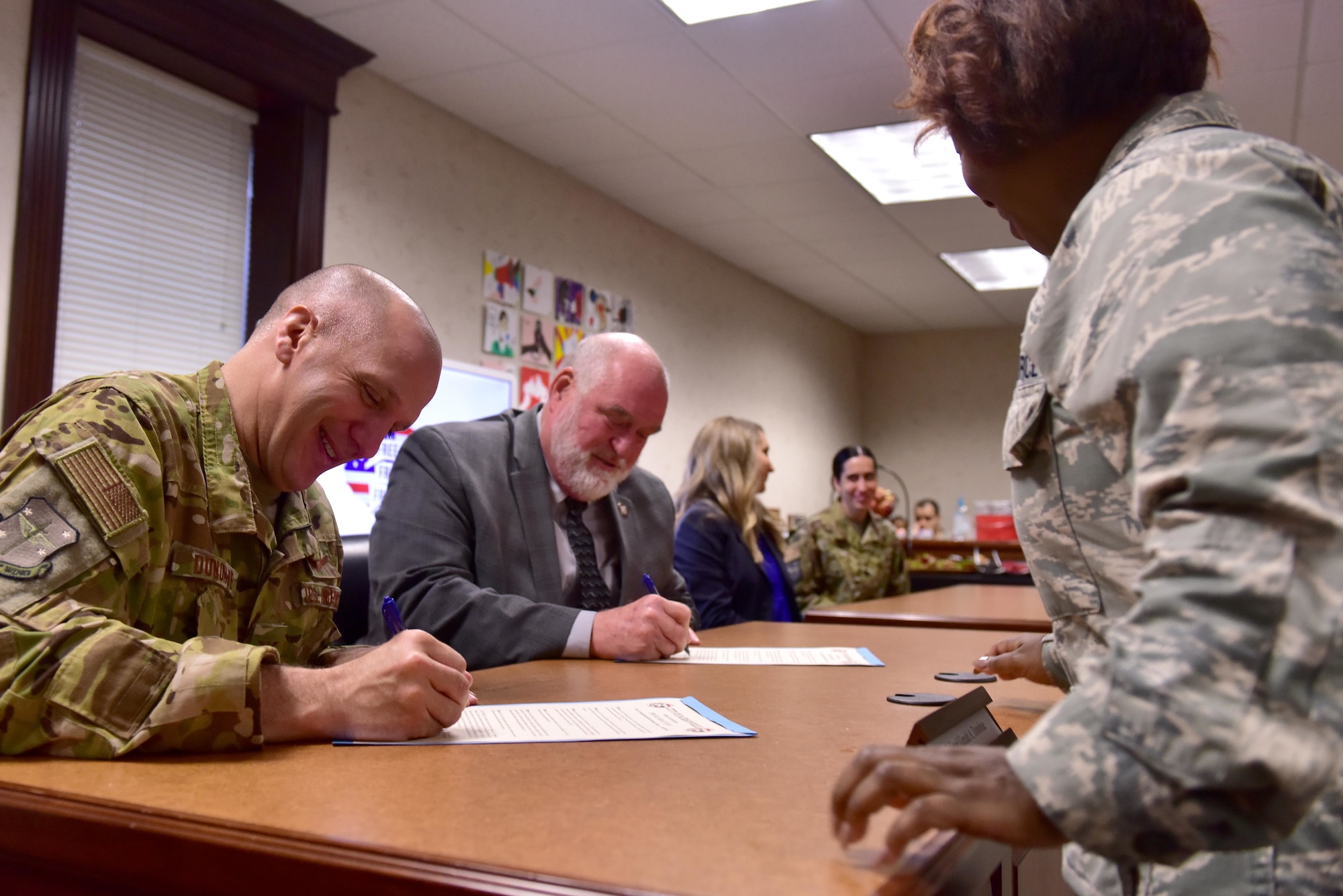 An Airman signs a proclamation