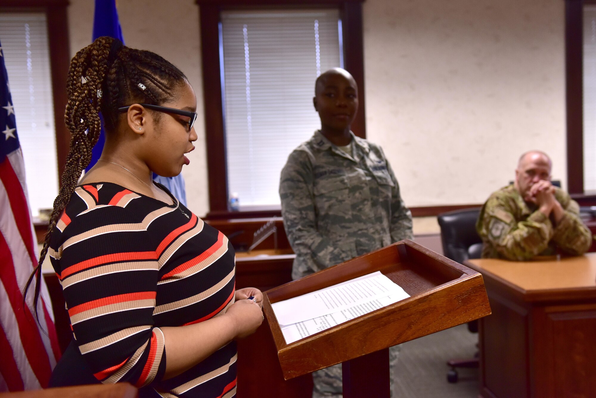 A student reads her essay at the podium