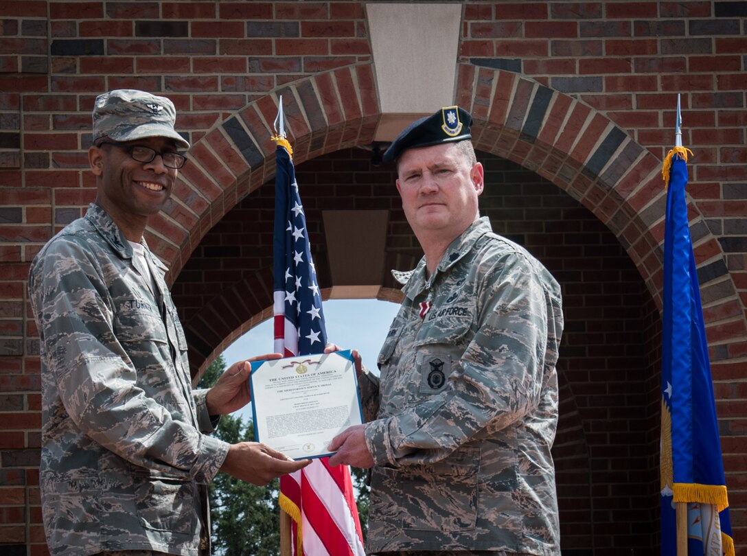 Lt. Col. James R. Blackburn III, commander, 932nd Security Forces Squadron, receives the Meritorious Service Medal from Col. Lance Turner, Mission Support Group commander, during an Assumption of Command ceremony, May 5, 2019, 375th Air Mobility Wing Parade Field, Scott Air Force Base, Illinois. Blackburn relinquished command to Maj. George D. Mokriakow.  (U.S. Air Force photo by Senior Airman Brooke Deiters)