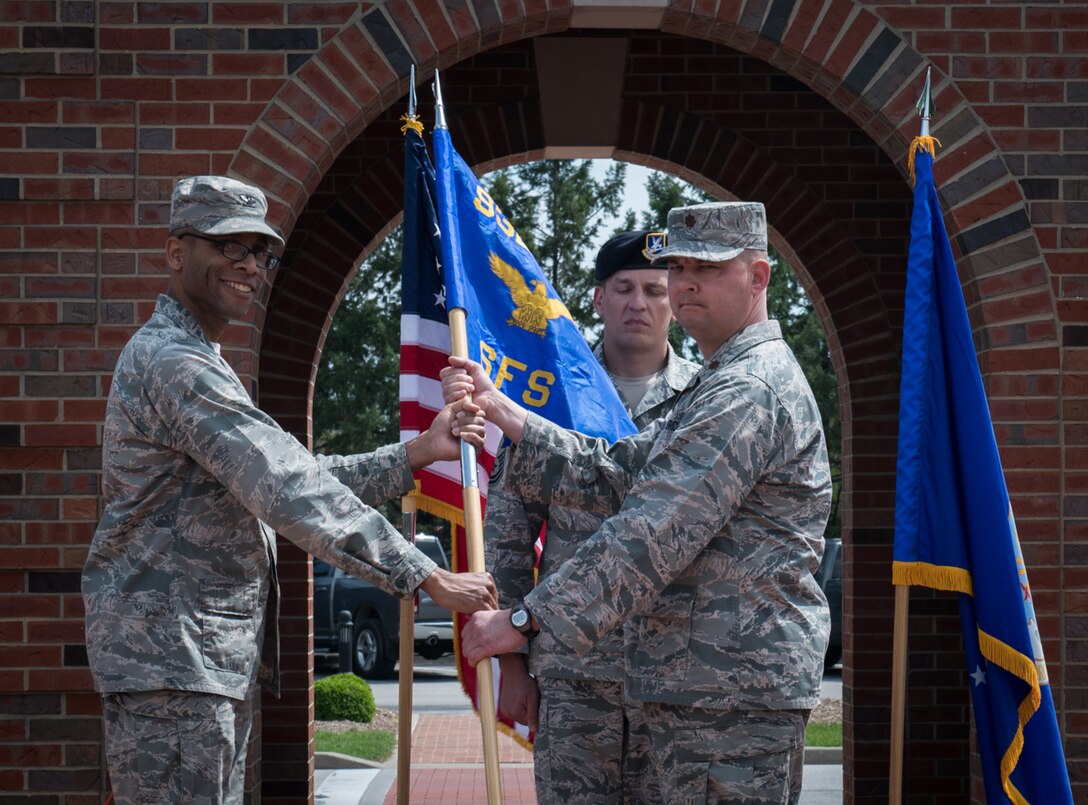 Maj. George D. Mokriakow receives the Security Forces guidon, thus taking command of the Security Forces Squadron, from Col. Lance Turner, commander, 932nd Mission Support Group, during an Assumption of Command ceremony, May 5, 2019, 375th Air Mobility Wing Parade Field, Scott Air Force Base, Illinois. Mokriakow moved from the 932nd Aeromedical Evacuation Squadron, where he was the operations flight commander. (U.S. Air Force photo by Senior Airman Brooke Deiters)