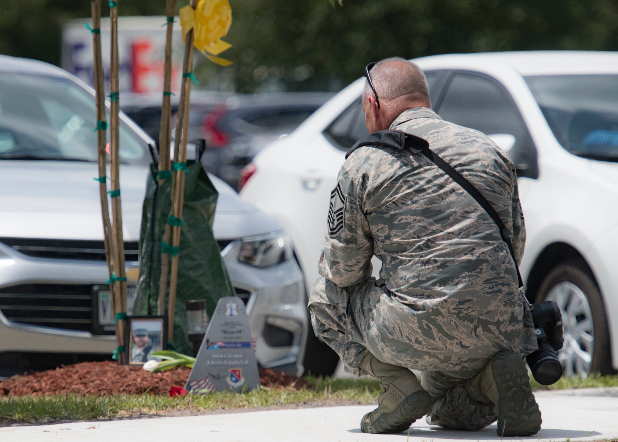 Senior Master Sgt. Roger Parsons, 116th Air Control Wing public affairs specialist, kneels at a tree planted in memory of a fallen Airman during a memorial ceremony May 2, 2019, in Port Wentworth, GA. The event paid homage to the lives of the nine Puerto Rican Air National Guard Airmen who lost their lives when their C-130 Hercules, assigned to the 156th Airlift Wing, crashed May 2, 2018.