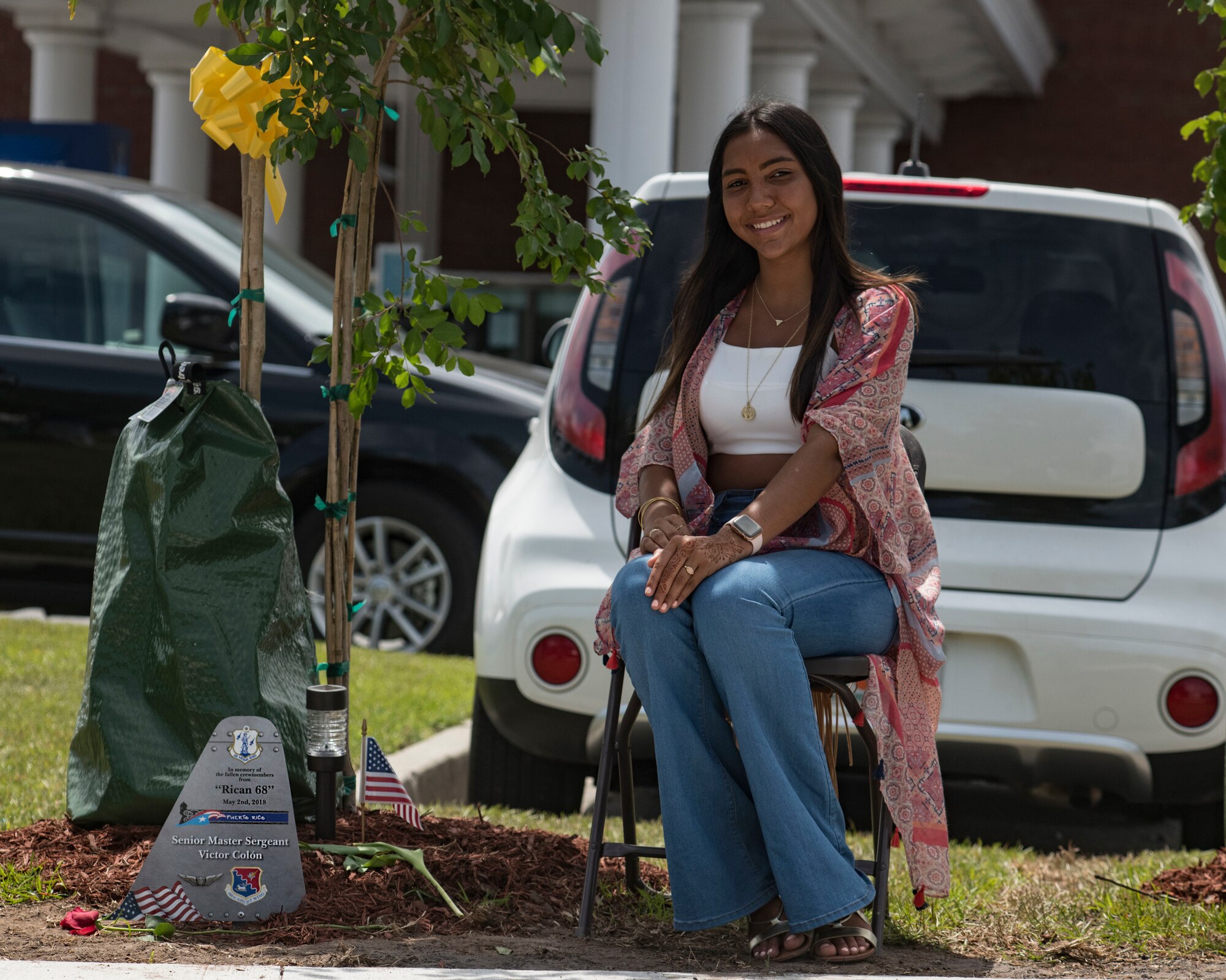 Valeria Colon, daughter of Master Sgt. Victor Colon, poses for a portrait next to a tree planted in her father’s honor after a memorial ceremony May 2, 2019, in Port Wentworth, GA. The event paid homage to the lives of the nine Puerto Rican Air National Guard Airmen who lost their lives when their C-130 Hercules, assigned to the 156th Airlift Wing, crashed May 2, 2018.