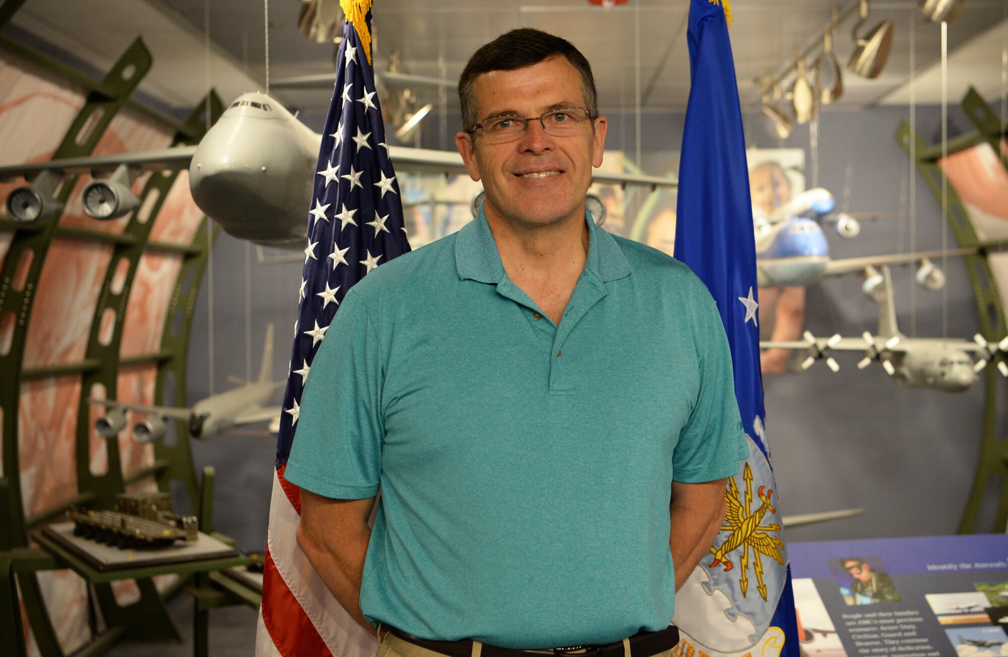 David Young, 60, Air Mobility Command current operations air mobility analyst and retired Air Force pilot, proudly stands by a model of a C-5 Galaxy at Scott Air Force Base, Ill., April 30, 2019. Young used to fly the aircraft when he was a pilot, and he helped build the display back when it was first installed. In his free time, Young volunteers in the Neonatal Intensive Care Unit at Mercy Hospital in St. Louis. (U.S. Air Force photo by Airman 1st Class Miranda Simpson)