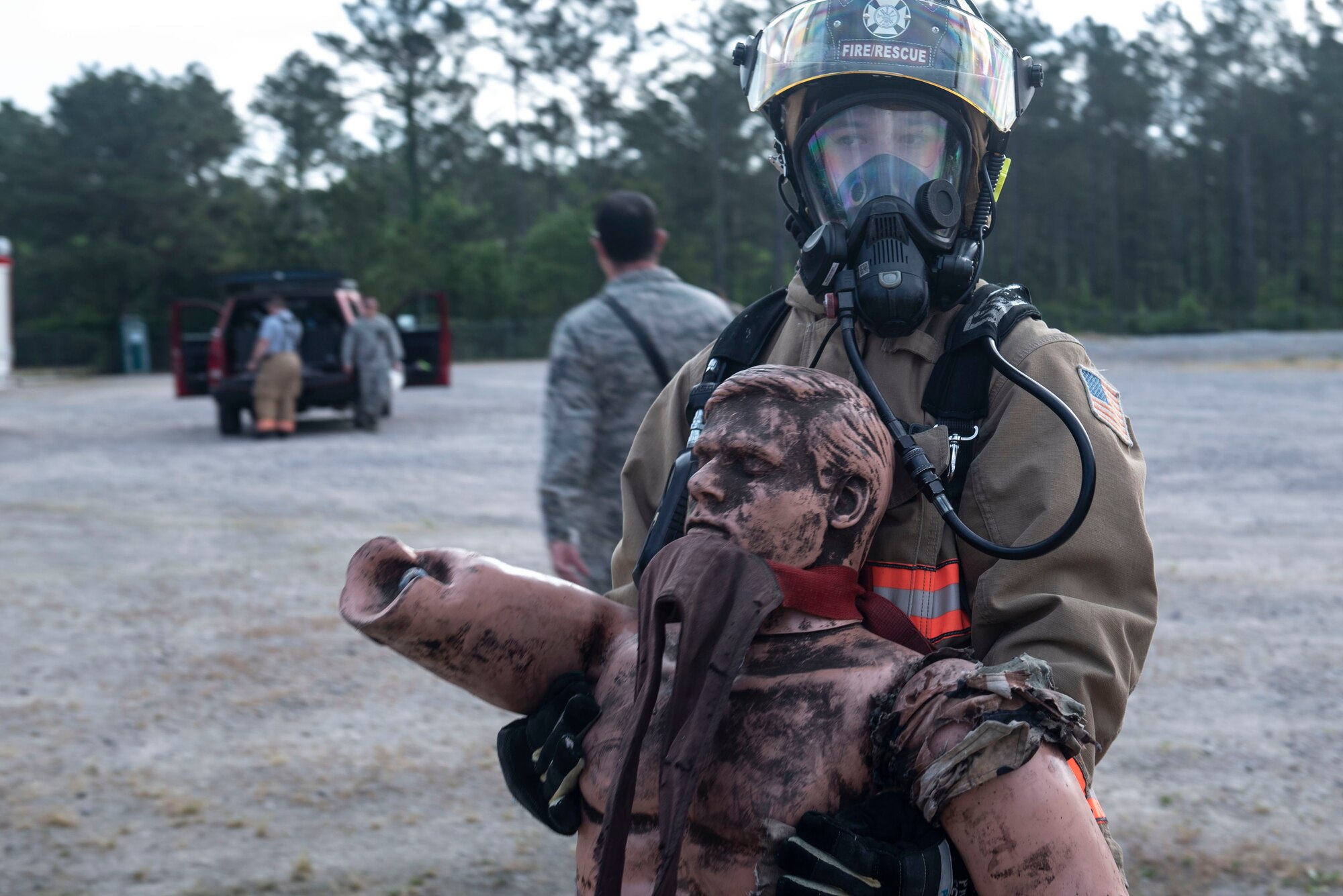A U.S. Air Force 20th Civil Engineer Squadron firefighter carries a simulated casualty away from a chemical and explosives lab during an exercise at Shaw Air Force Base, S.C., May 2, 2019.
