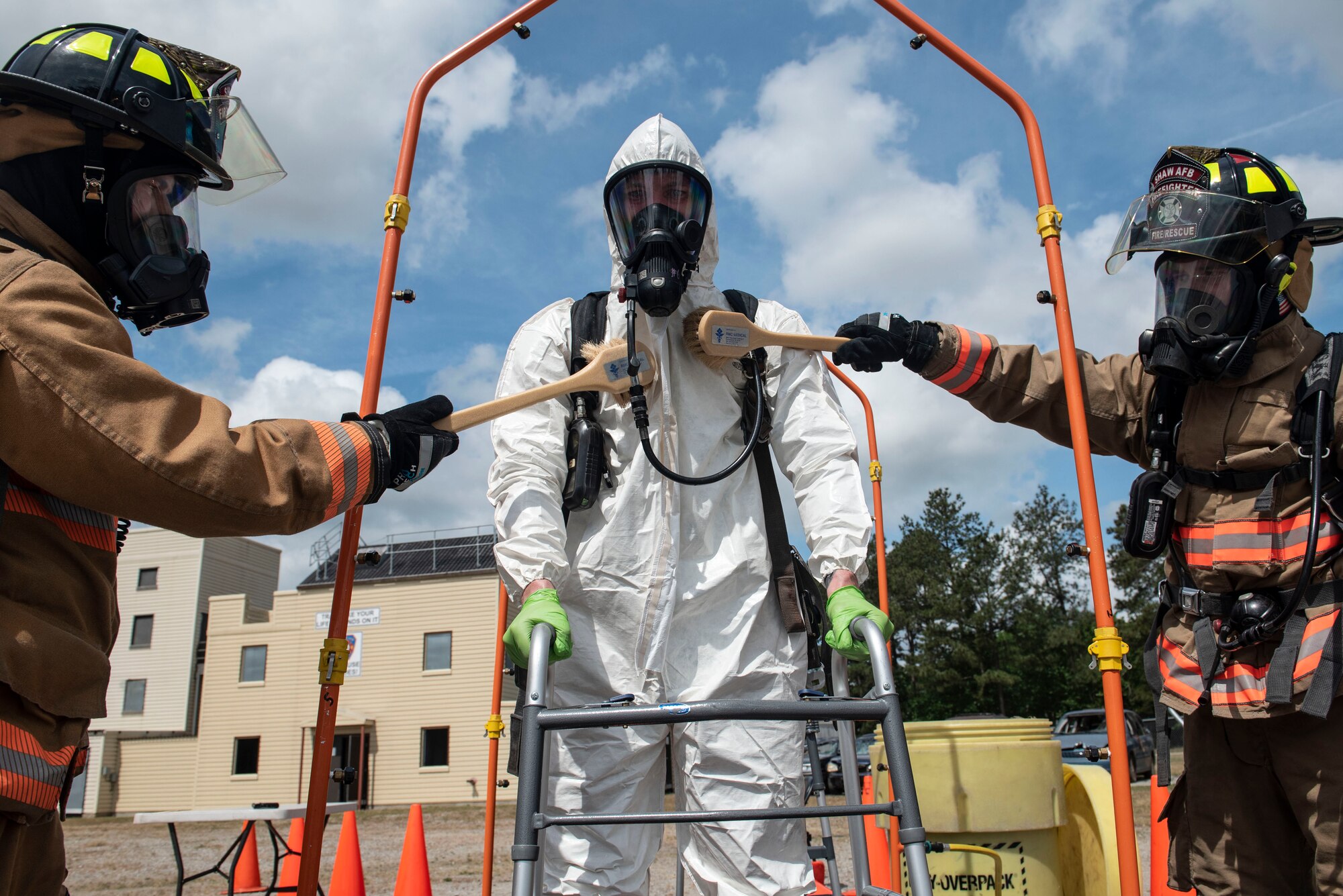 U.S. Air Force firefighters assigned to the 20th Civil Engineer Squadron simulate decontaminating their wingman during an exercise at Shaw Air Force Base, S.C., May 2, 2019.