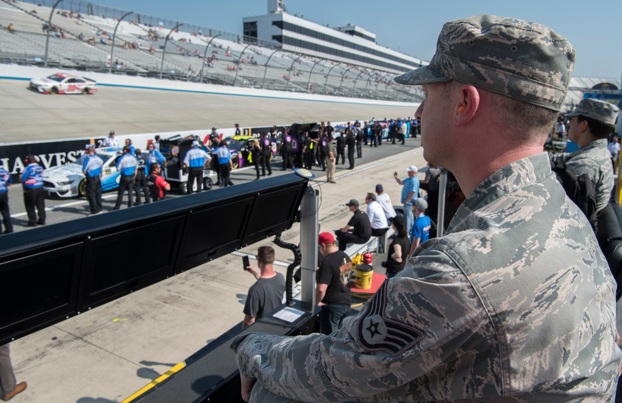 Staff Sgt. Matthew Tatum, 436th Airlift Wing religious affairs Airman, watches the Monster Energy NASCAR Cup Series qualifying race May 3, 2019, at Dover International Speedway, Dover, Del. Tatum,a huge fan of NASCAR, was selected to be one of the approximately 35  honorary pit crew members from Dover Air Force Base. The weekend marked Dover International Speedway’s 50th season and the Monster Mile’s 100th Monster Energy NASCAR Cup Series race. (U.S. Air Force photo by Senior Airman Christopher Quail)