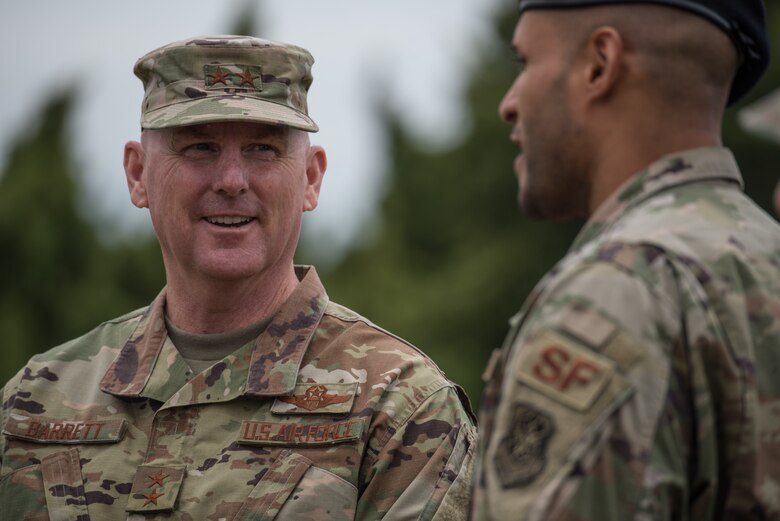 Maj. Gen. Sam Barrett, 18th Air Force commander, speaks to Tech. Sgt. Elvin Jose, 22nd Security Forces Squadron military working dog handler during a MWD demonstration May, 3, 2019, at McConnell Air Force Base, Kan. Barrett’s visit consisted of many interactions with McConnell Airmen while they showed how the instillation supports the refueling mission. (U.S. Air Force photo by Senior Airman Alan Ricker)