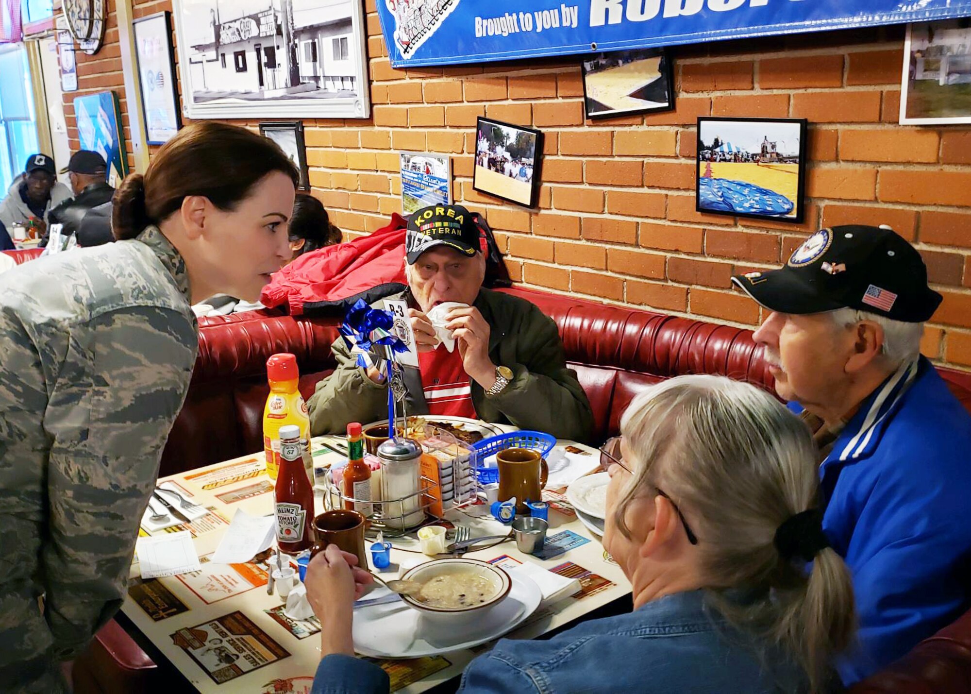 Lt. Col. Neva VanDerSchaegen, 412th Medical Support Squadron commander to talks Art Ray, a World War II Veteran during a Coffee4Vets event in Lancaster, Calif., May 7. Coffee4Vets meets every Tuesday at Crazy Otto’s Diner in Lancaster. The group allows currently-serving Airmen to engage with local Veterans and bridges different generations of servicemembers. (U.S. Air Force photo by Danny Bazzell)