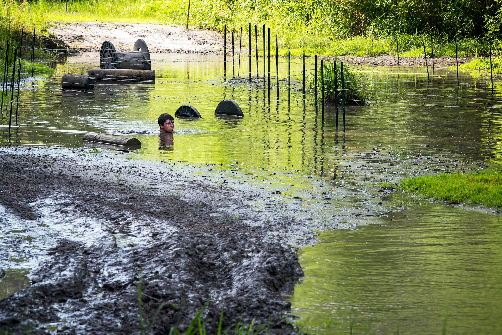 A Moody Mud Run participant, swims through an obstacle, May 4, 2019, in Ray City, Ga. The sixth annual Mud Run had approximately 850 participants who had to overcome a series of obstacles on the 4 and 5-mile courses. The 32-obstacle course gave Airmen, families and the local community an opportunity to build camaraderie and teamwork skills. (U.S. Air Force photo by Airman 1st Class Eugene Oliver)