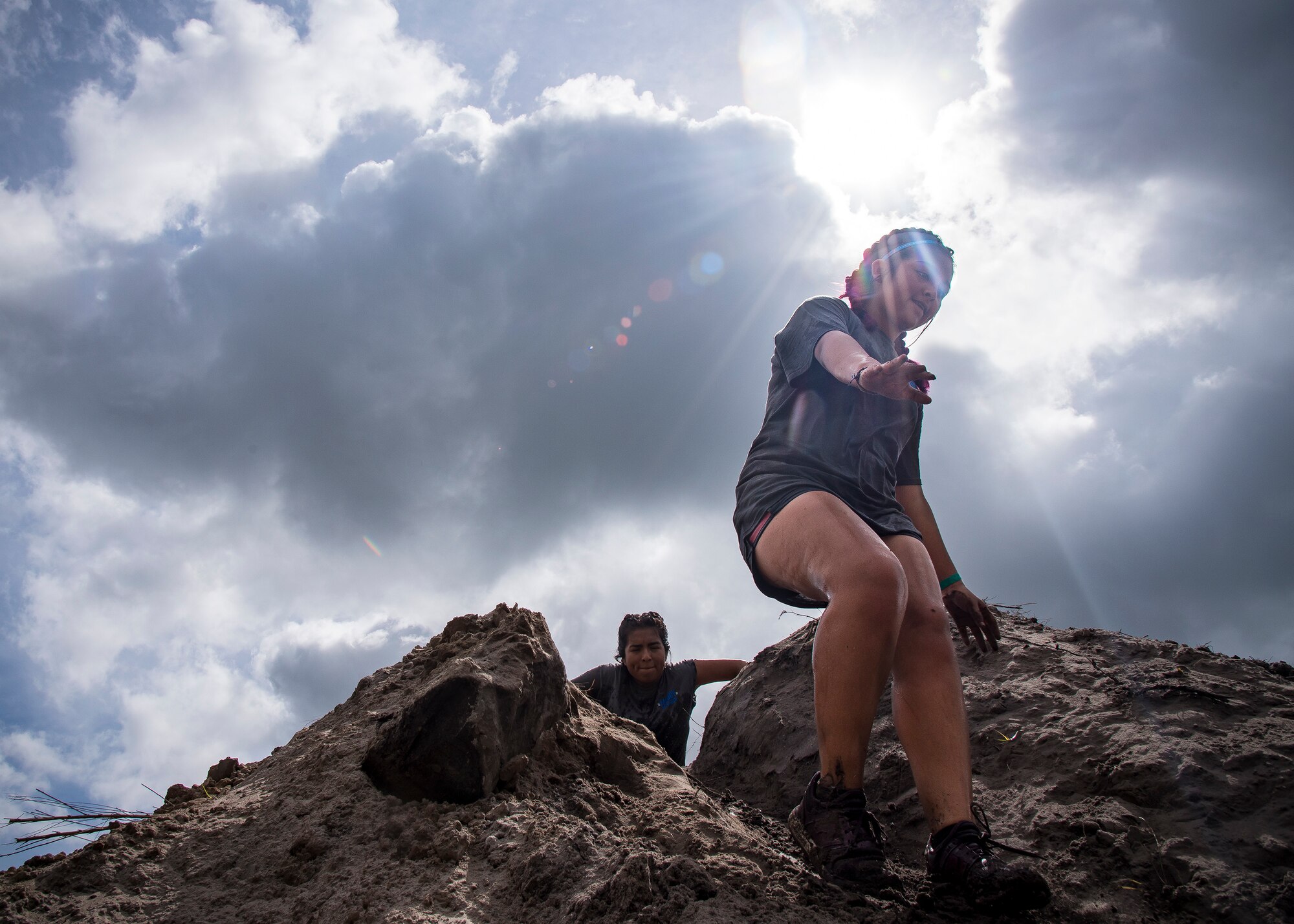 Moody Mud Run participants slide down an incline, May 4, 2019, in Ray City, Ga. The sixth annual Mud Run had approximately 850 participants who had to overcome a series of obstacles on the 4 and 5-mile courses. The 32-obstacle course gave Airmen, families and the local community an opportunity to build camaraderie and teamwork skills. (U.S. Air Force photo by Airman 1st Class Eugene Oliver)