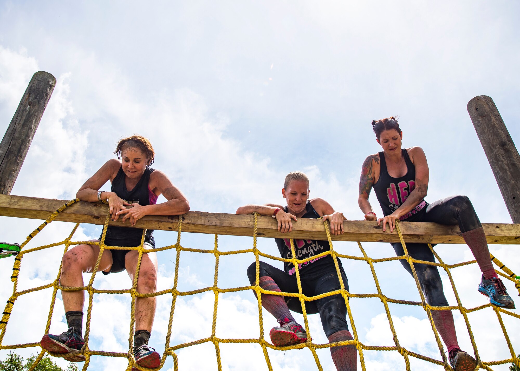 Moody Mud Run participants climb a rope obstacle, May 4, 2019, in Ray City, Ga. The sixth annual Mud Run had approximately 850 participants who had to overcome a series of obstacles on the 4 and 5-mile courses. The 32-obstacle course gave Airmen, families and the local community an opportunity to build camaraderie and teamwork skills. (U.S. Air Force photo by Airman 1st Class Eugene Oliver)