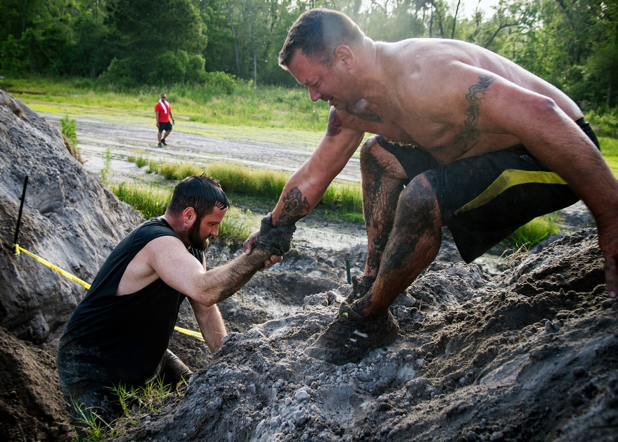 Moody Mud Run participants climp up an incline, May 4, 2019, in Ray City, Ga. The sixth annual Mud Run had approximately 850 participants who had to overcome a series of obstacles on the 4 and 5-mile courses. The 32-obstacle course gave Airmen, families and the local community an opportunity to build camaraderie and teamwork skills. (U.S. Air Force photo by Airman 1st Class Eugene Oliver)