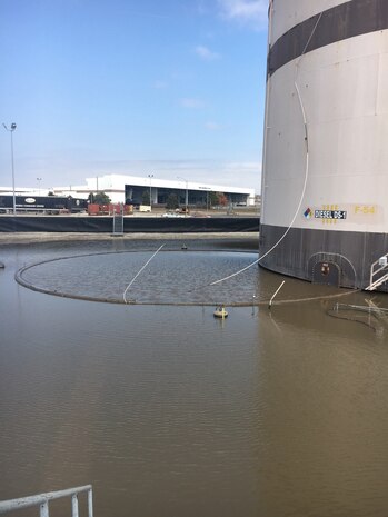 As a precautionary measure, a boom is deployed at one of the bulk fuel storage tanks at Offut Air Force Base, Nebraska, after flooding occurred there in March. A U.S. Army Engineering and Support Center, Huntsville Fuels Program contract ensures repairs will be made to the base's bulk fuel storage facilities.