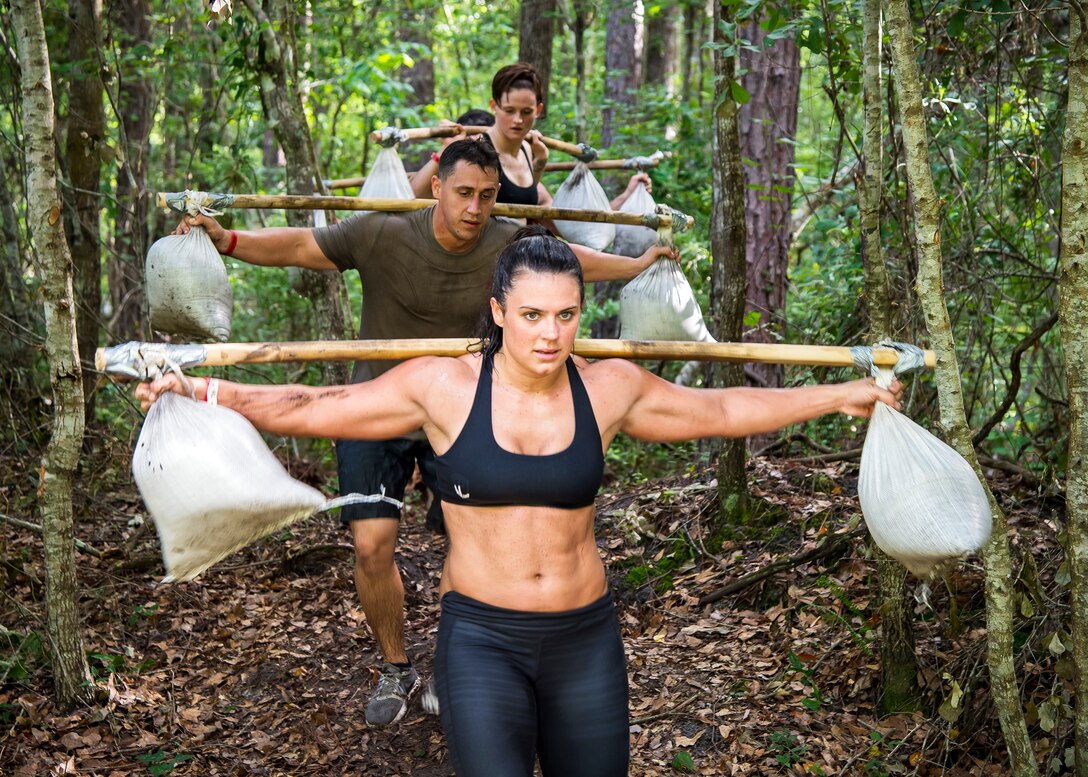 Moody Mud Run participants carry sandbags, May 4, 2019, in Ray City, Ga. The sixth annual Mud Run had approximately 850 participants who had to overcome a series of obstacles on the 4 and 5-mile courses. The 32-obstacle course gave Airmen, families and the local community an opportunity to build camaraderie and teamwork skills. (U.S. Air Force photo by Airman 1st Class Eugene Oliver)