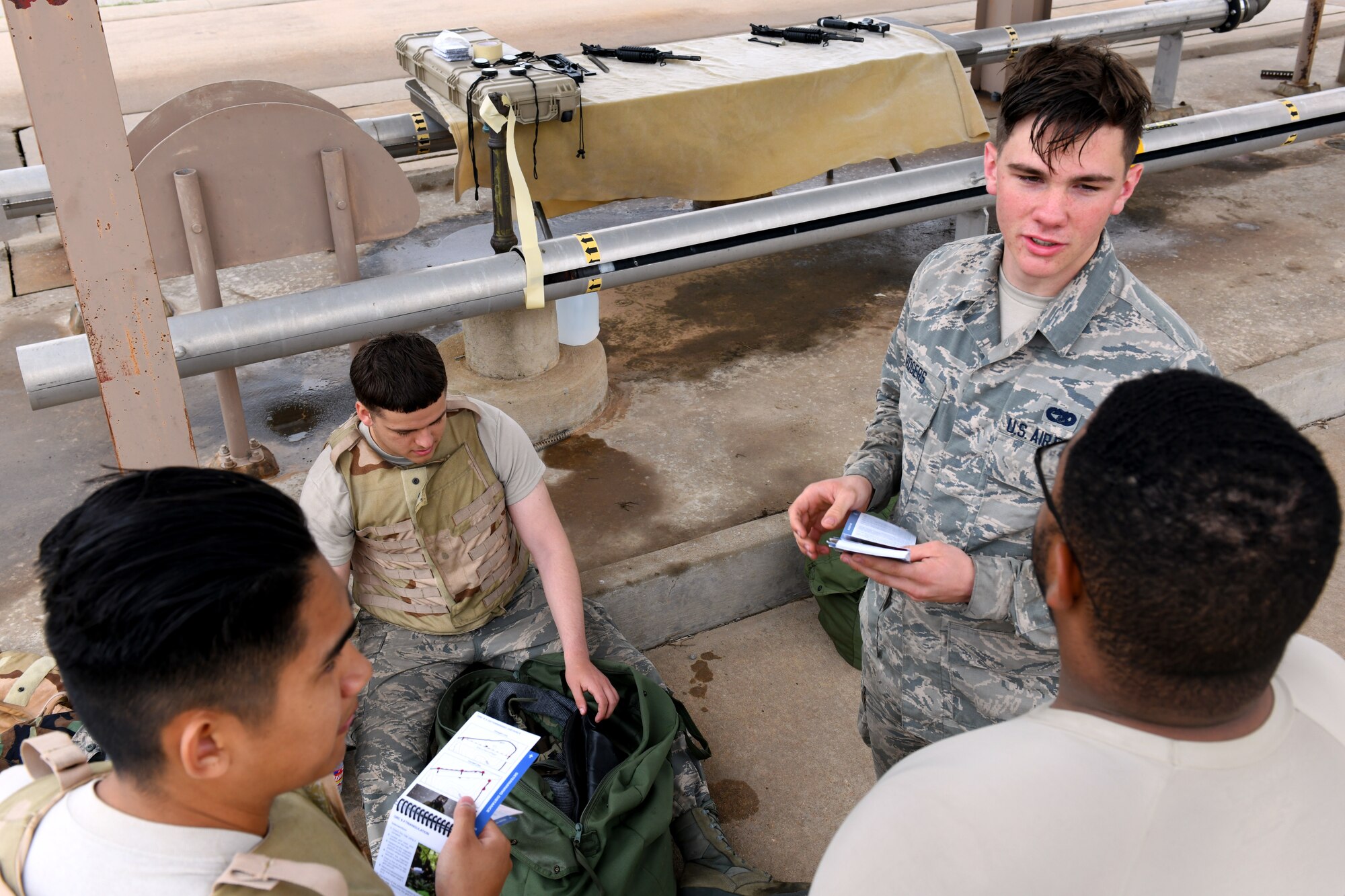 U.S. Air Force Airmen from the 97th Logistics Readiness Squadron Air Operations Flight read their Airman’s Quick References during the LRS Warrior Challenge May 6, 2019, at Altus Air Force Base, Okla. While participating in the event, they completed challenges measuring both their physical strength and military knowledge. (U.S. Air Force photo by Technical Sergeant Robert Sizelove)