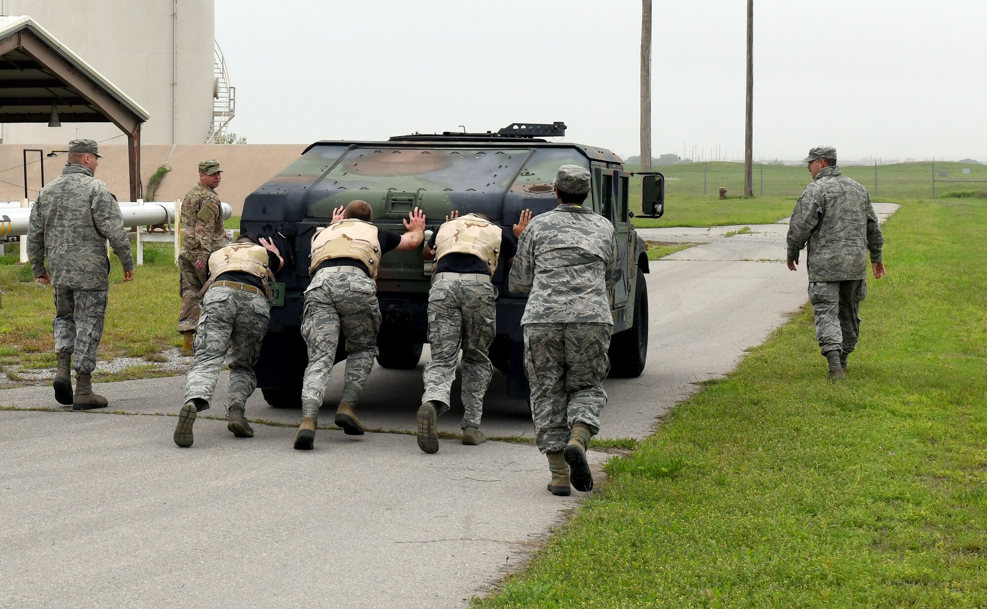 Members of the 97th Communications Squadron push a High Mobility Multipurpose Wheeled Vehicle during the 97th Logistics Readiness Squadron Warrior Challenge May 6, 2019, at Altus Air Force Base, Okla. While participating in the event, the team members completed in challenges to test their knowledge of military regulations, in addition to physical strength and endurance components. (U.S. Air Force photo by Technical Sergeant Robert Sizelove)