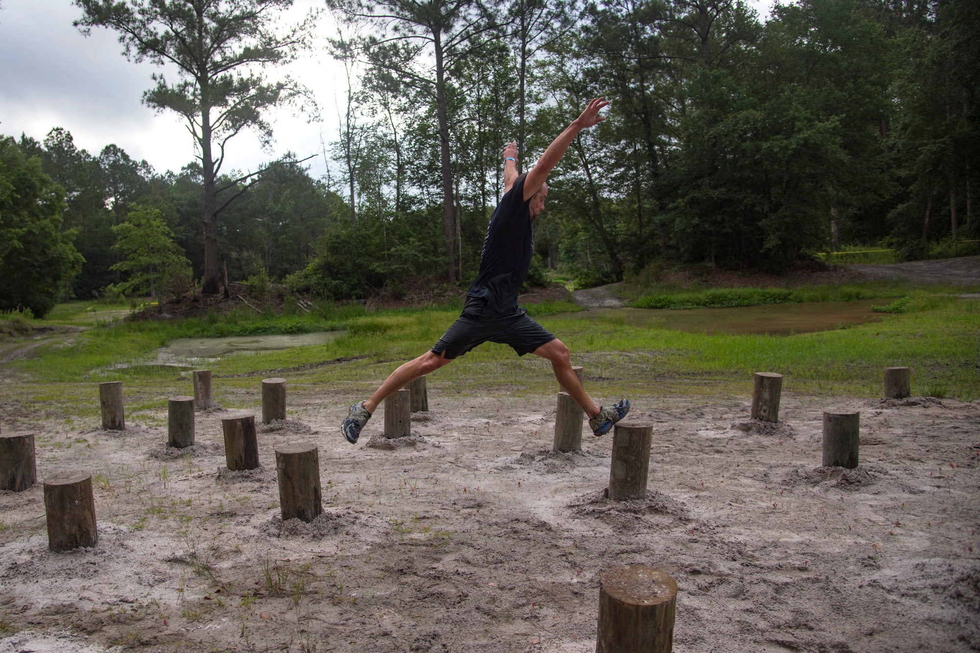A participant leaps from log to log during the Moody Mud Run, May 4, 2019, at Possum Creek Off-Road Park in Ray City, Ga. The sixth annual Moody Mud Run had approximately 850 participants who had to overcome a series of obstacles on the 4 and 5-mile courses. The 32-obstacle course gave Airmen, families and the local community an opportunity to build camaraderie and teamwork skills. (U.S. Air Force Photo by Airman 1st Class Taryn Butler)