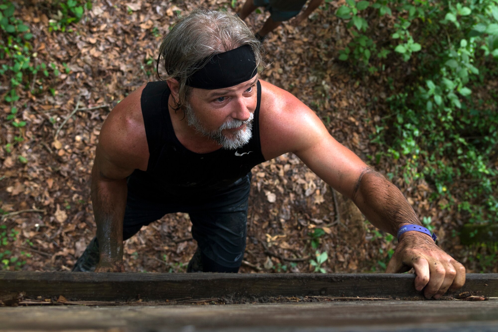 A participant climbs a 12-foot wall during the Moody Mud Run, May 4, 2019, at Possum Creek Off-Road Park in Ray City, Ga. The sixth annual Moody Mud Run had approximately 850 participants who had to overcome a series of obstacles on the 4 and 5-mile courses. The 32-obstacle course gave Airmen, families and the local community an opportunity to build camaraderie and teamwork skills. (U.S. Air Force Photo by Airman 1st Class Taryn Butler)