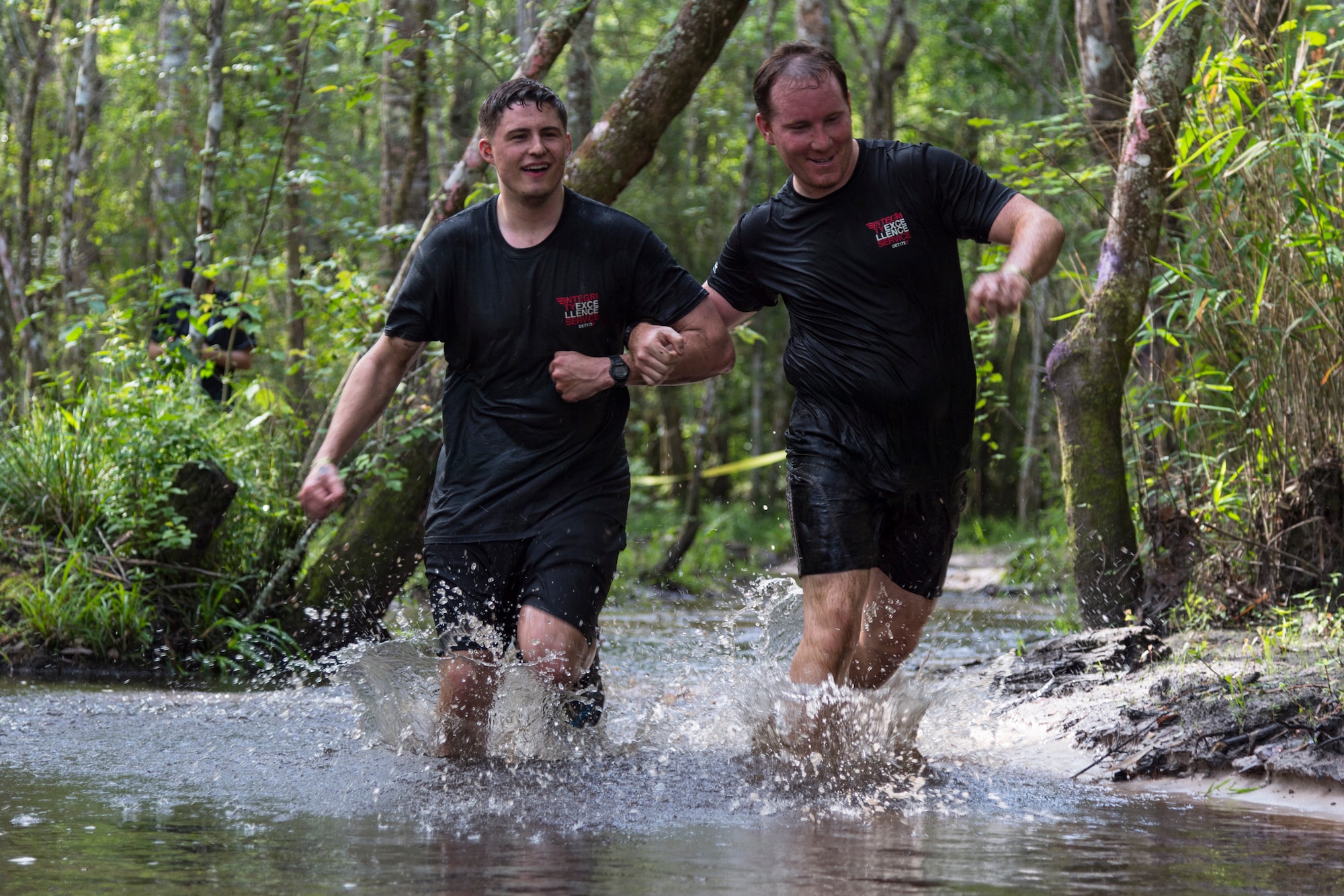 Participants run through a creek during the Moody Mud Run, May 4, 2019, at Possum Creek Off-Road Park in Ray City, Ga. The sixth annual Moody Mud Run had approximately 850 participants who had to overcome a series of obstacles on the 4 and 5-mile courses. The 32-obstacle course gave Airmen, families and the local community an opportunity to build camaraderie and teamwork skills. (U.S. Air Force Photo by Airman 1st Class Taryn Butler)
