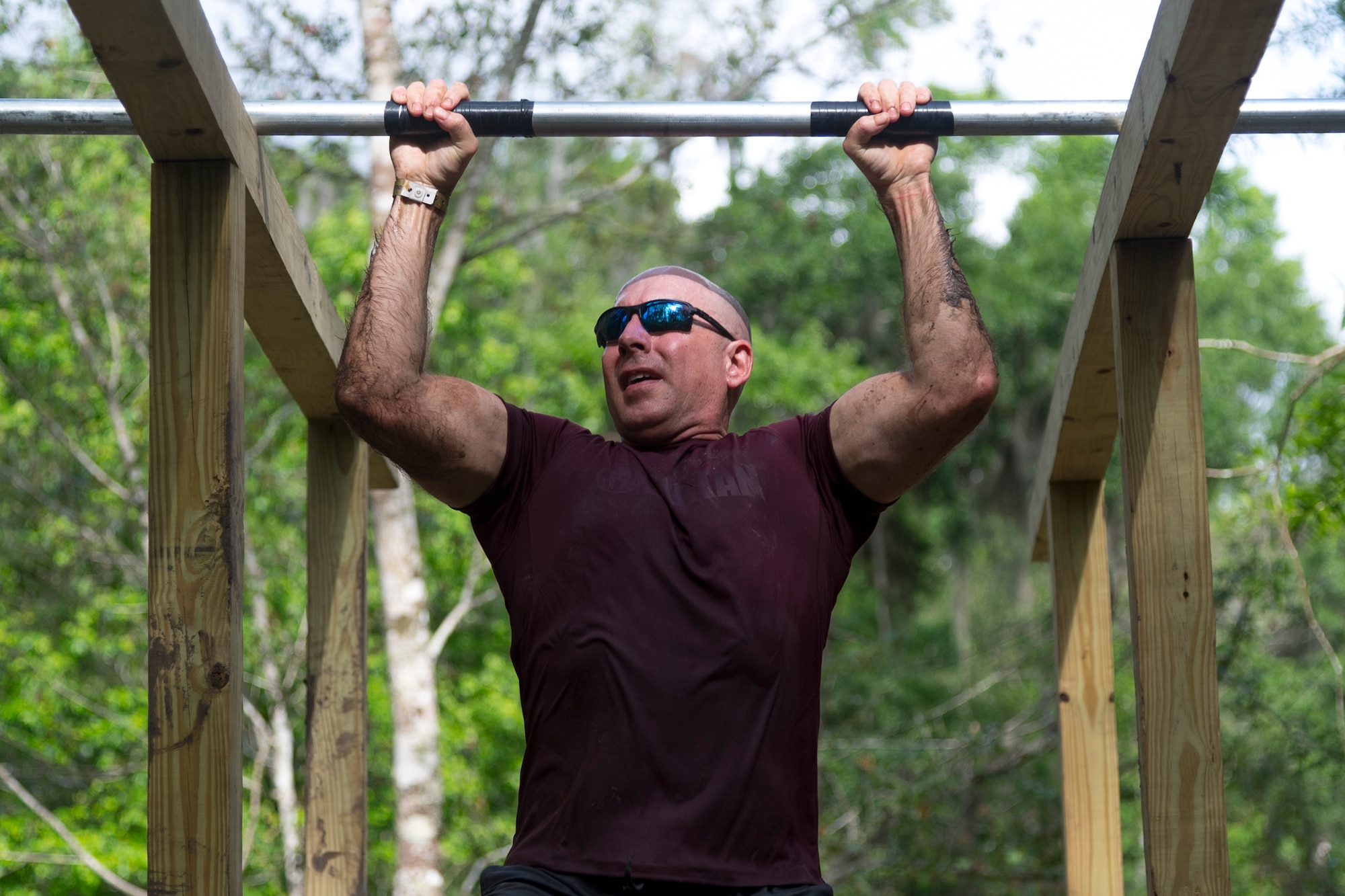A participant shimmies across wooden planks during the Moody Mud Run, May 4, 2019, at Possum Creek Off-Road Park in Ray City, Ga. The sixth annual Moody Mud Run had approximately 850 participants who had to overcome a series of obstacles on the 4 and 5-mile courses. The 32-obstacle course gave Airmen, families and the local community an opportunity to build camaraderie and teamwork skills. (U.S. Air Force Photo by Airman 1st Class Taryn Butler)
