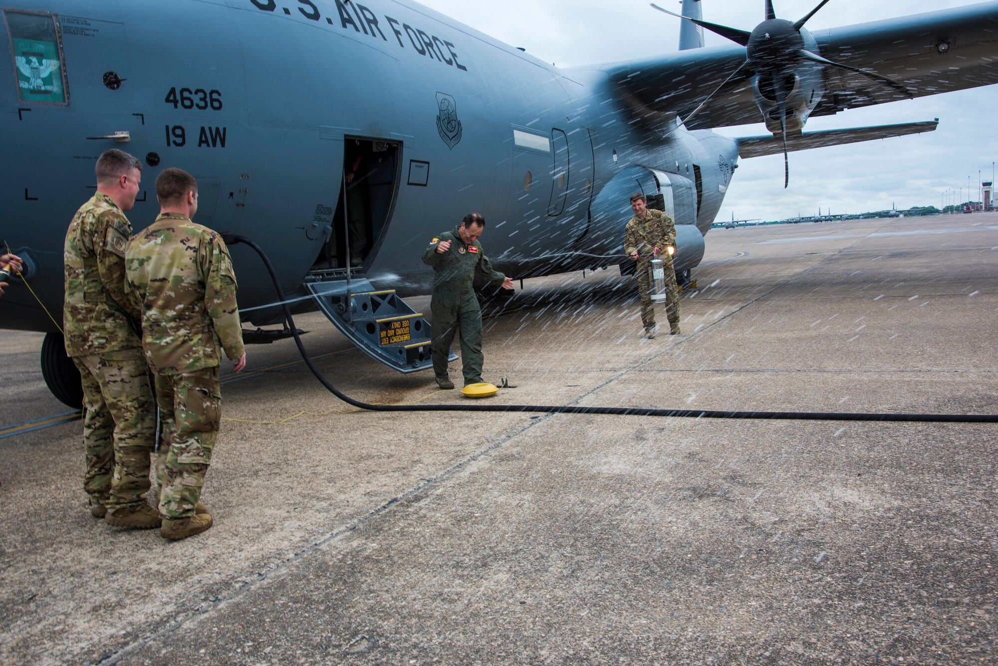 U.S. Air Force Reserve Col. Anthony Brusca, 913th Airlift Group deputy commander, steps off the aircraft to be doused in water after his last flight in the Air Force at Little Rock Air Force Base, Ark. on May 3, 2019