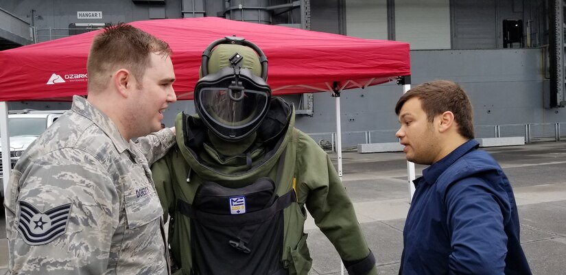Tech. Sgt. Jared Doherty, 514th  Explosive Ordnance Disposal team lead, talks about the purpose and capabilities of a bomb suit with an Air Force Convention attendee at the Intrepid Sea, Air & Space Museum during the Air Force Convention in New York City, May 4, 2019.
