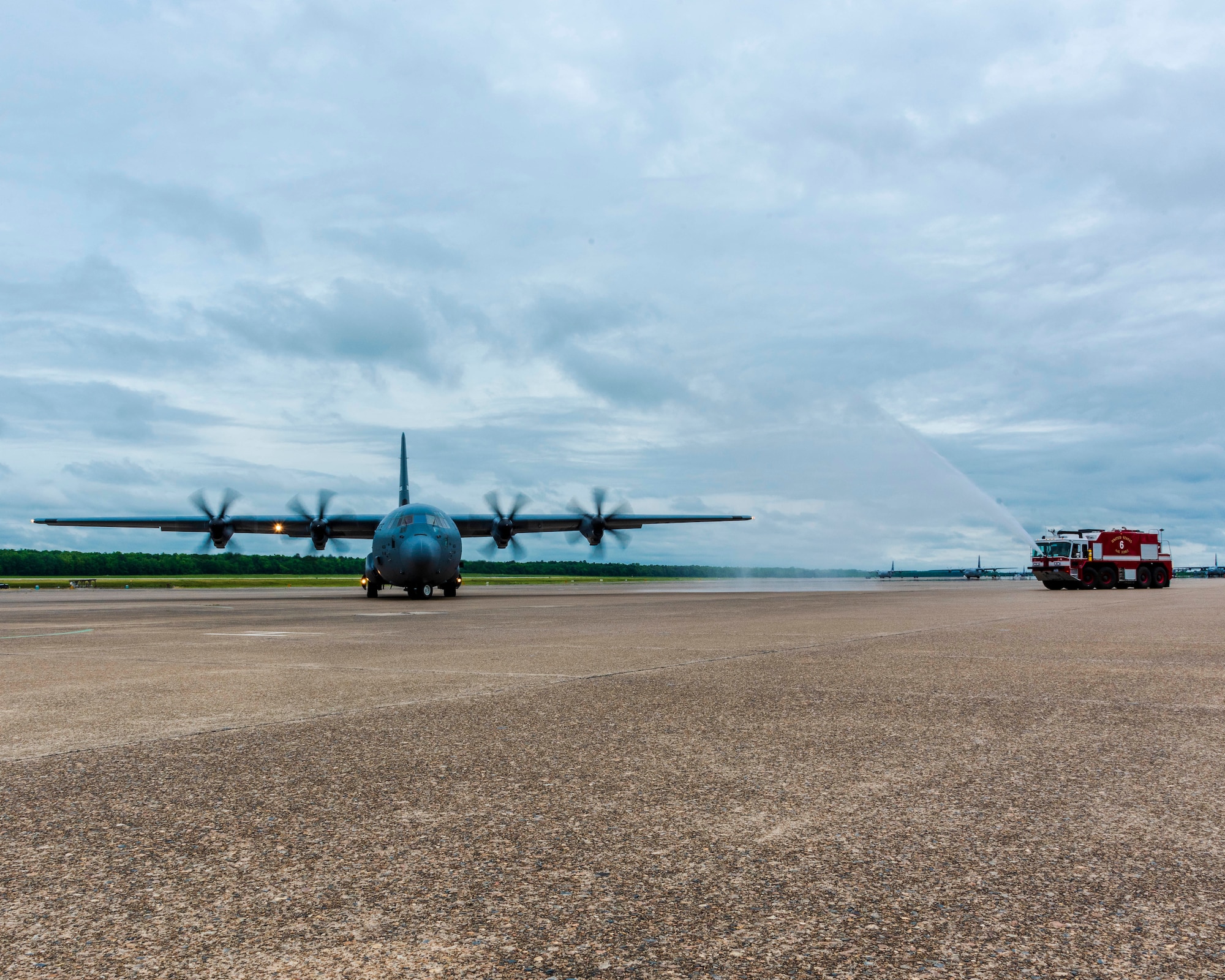 U.S. Air Force Reserve Col. Anthony Brusca, 913th Airlift Group deputy commander, taxis the aircraft as the base fire department douses the aircraft to celebrate his last flight at Little Rock Air Force Base, Ark. on May 3, 2019.